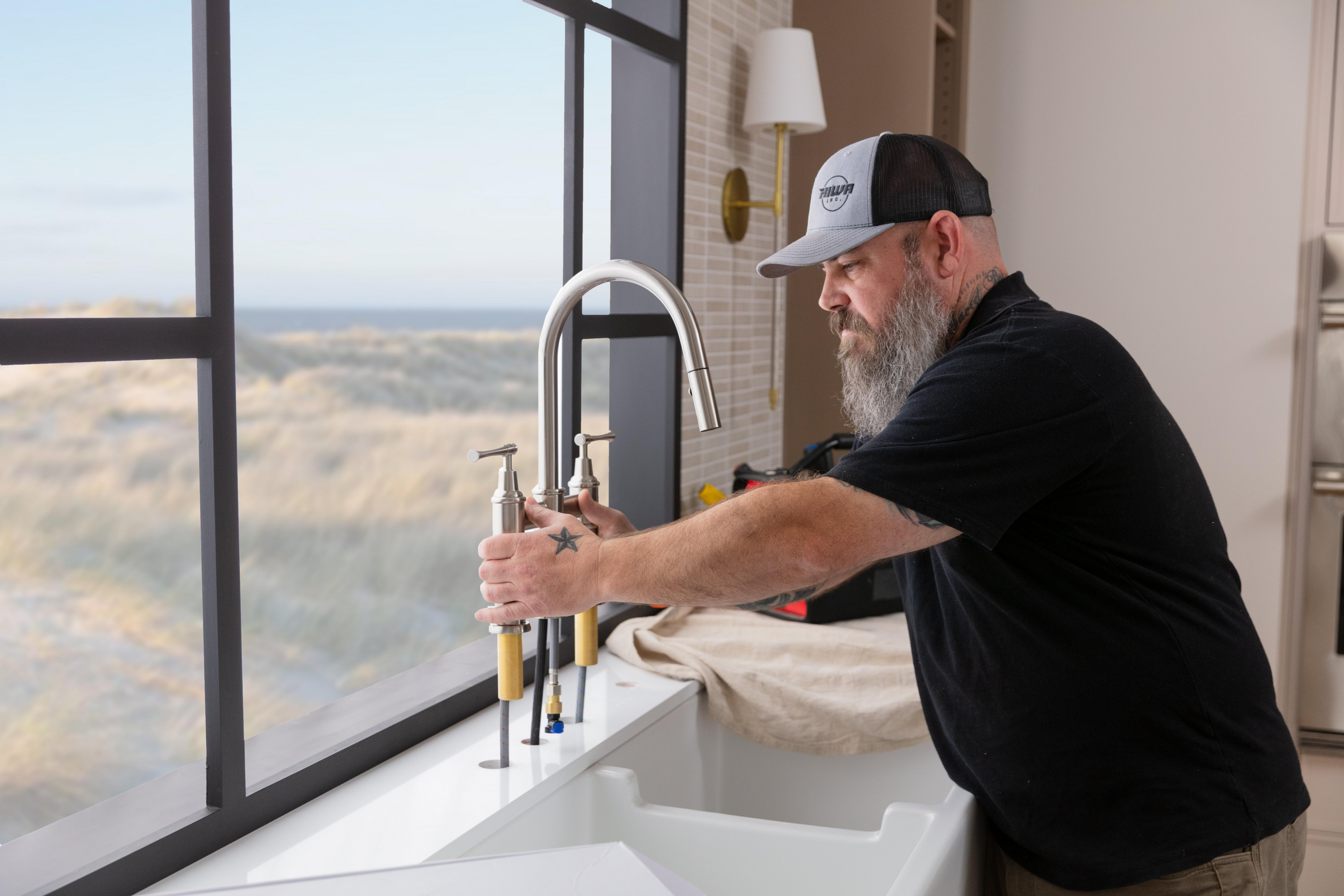 Lifestyle image of stainless steel double basin sink with kitchen faucet.